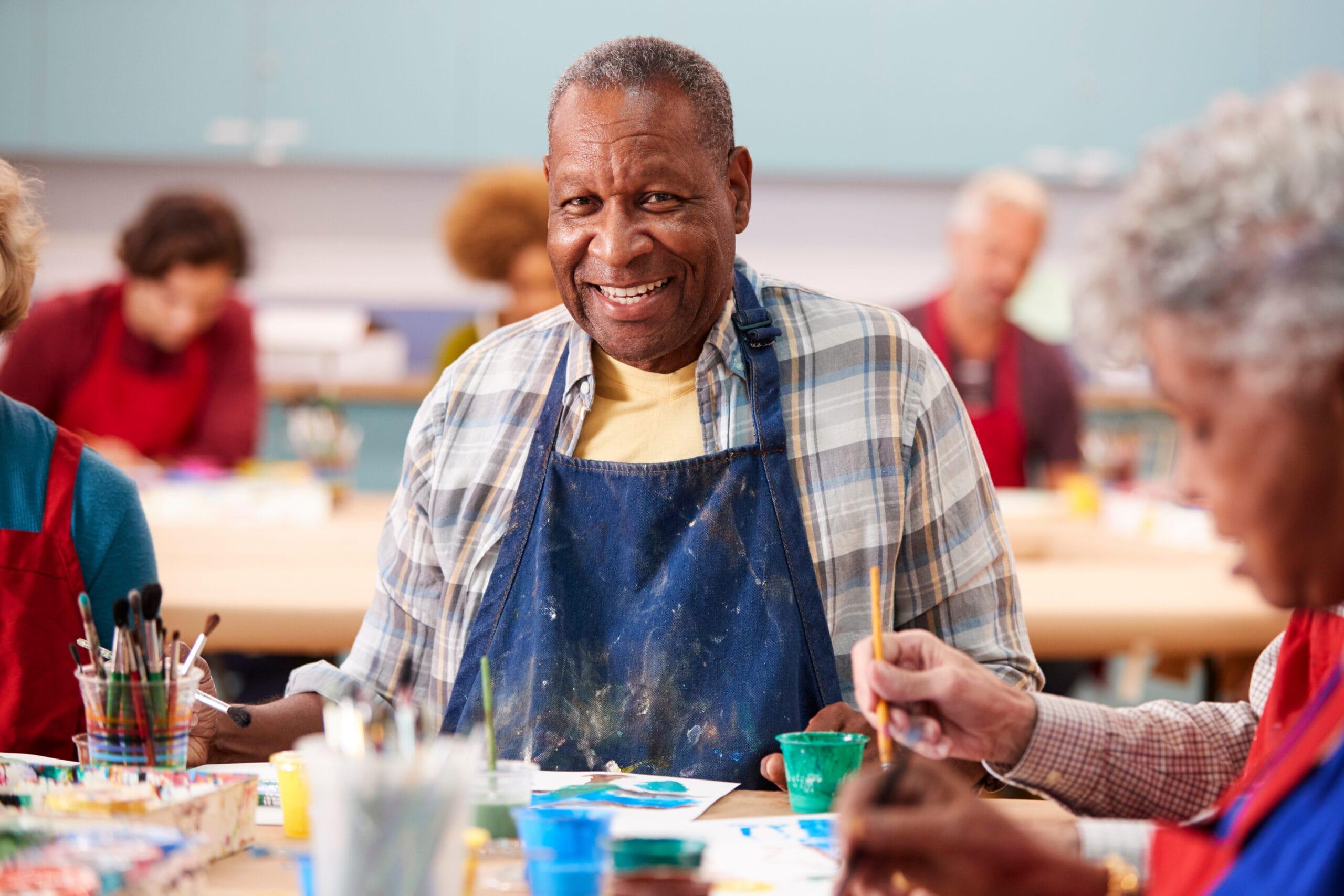 Portrait Of Retired Senior Man Attending Art Class In Community Centre