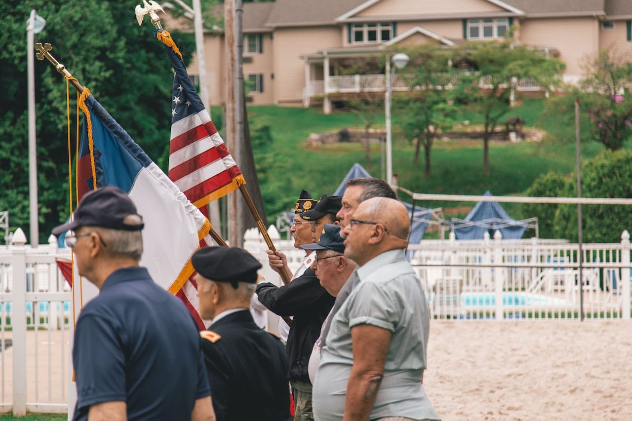 Older men standing near US flags