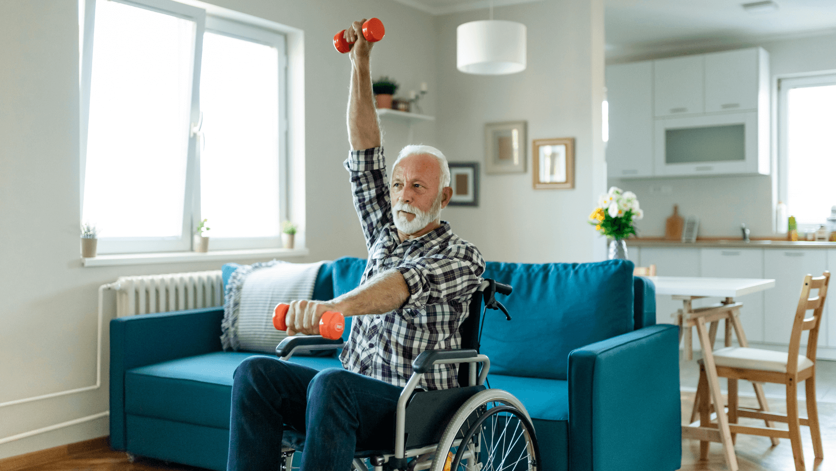 older man in a wheelchair doing dumbbell front raises