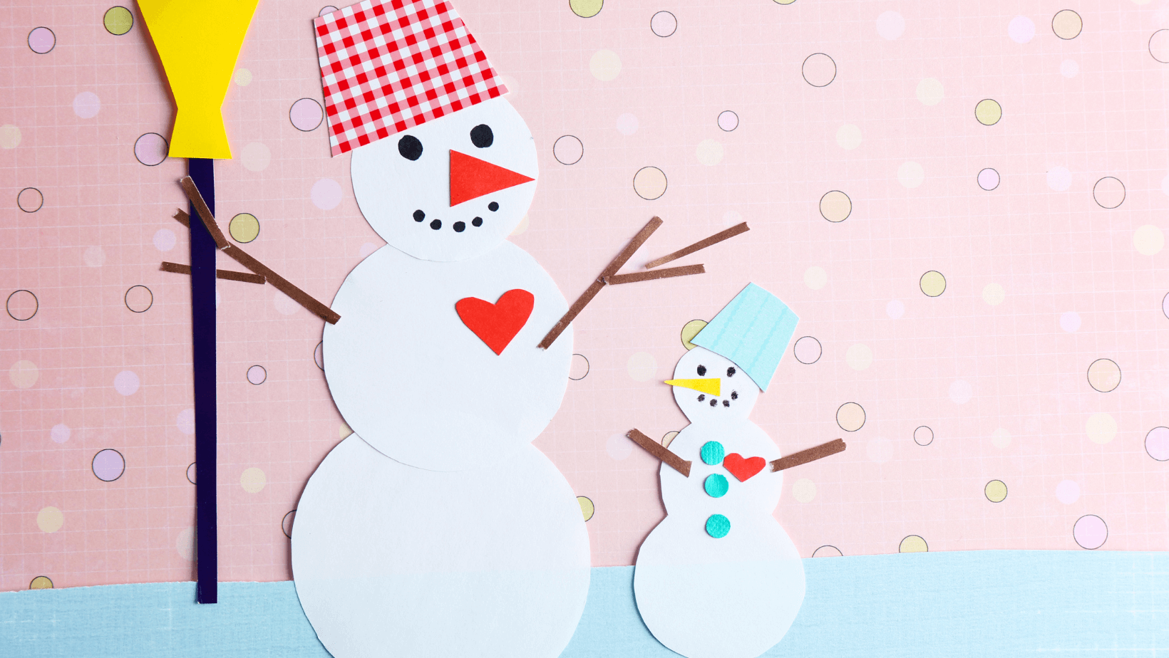 paper snowmen, one wearing a red hat and holding a broom