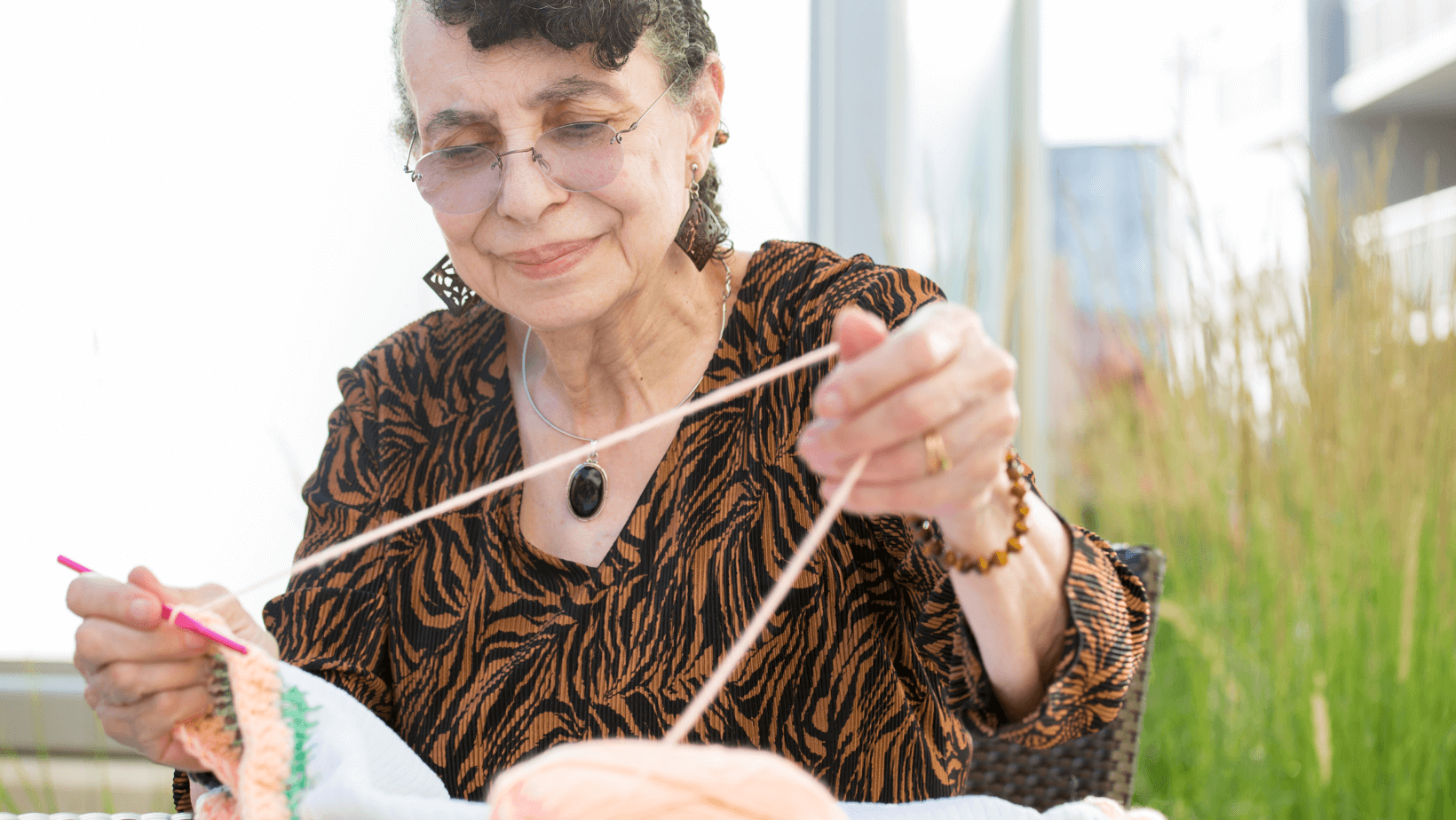 a senior woman crochets