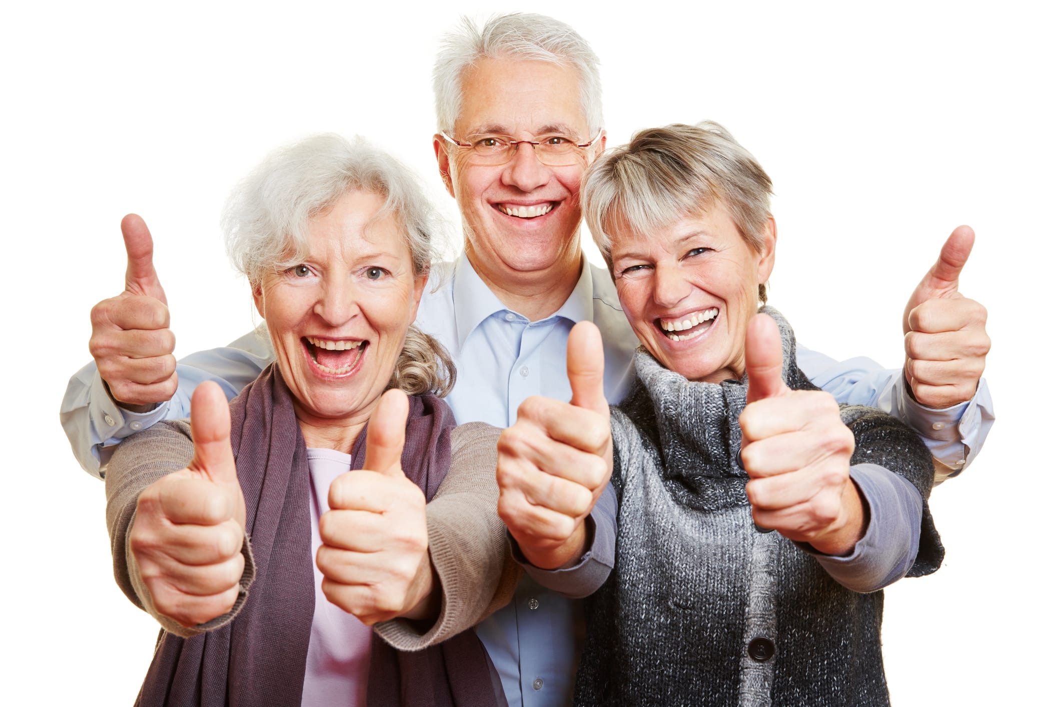Three elderly people smiling with thumbs up